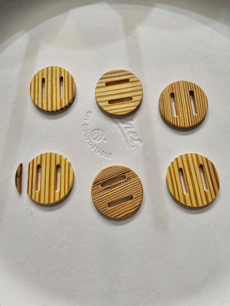 WeatherWool loves to use Slot Buttons, but there are not many factory-made choices, so we are working on our own.  These are made from antique wood, which is evidently not strong enough, as button on lower left fractured during shipping